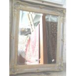 Wall mirror with bevelled glass & decorative frame