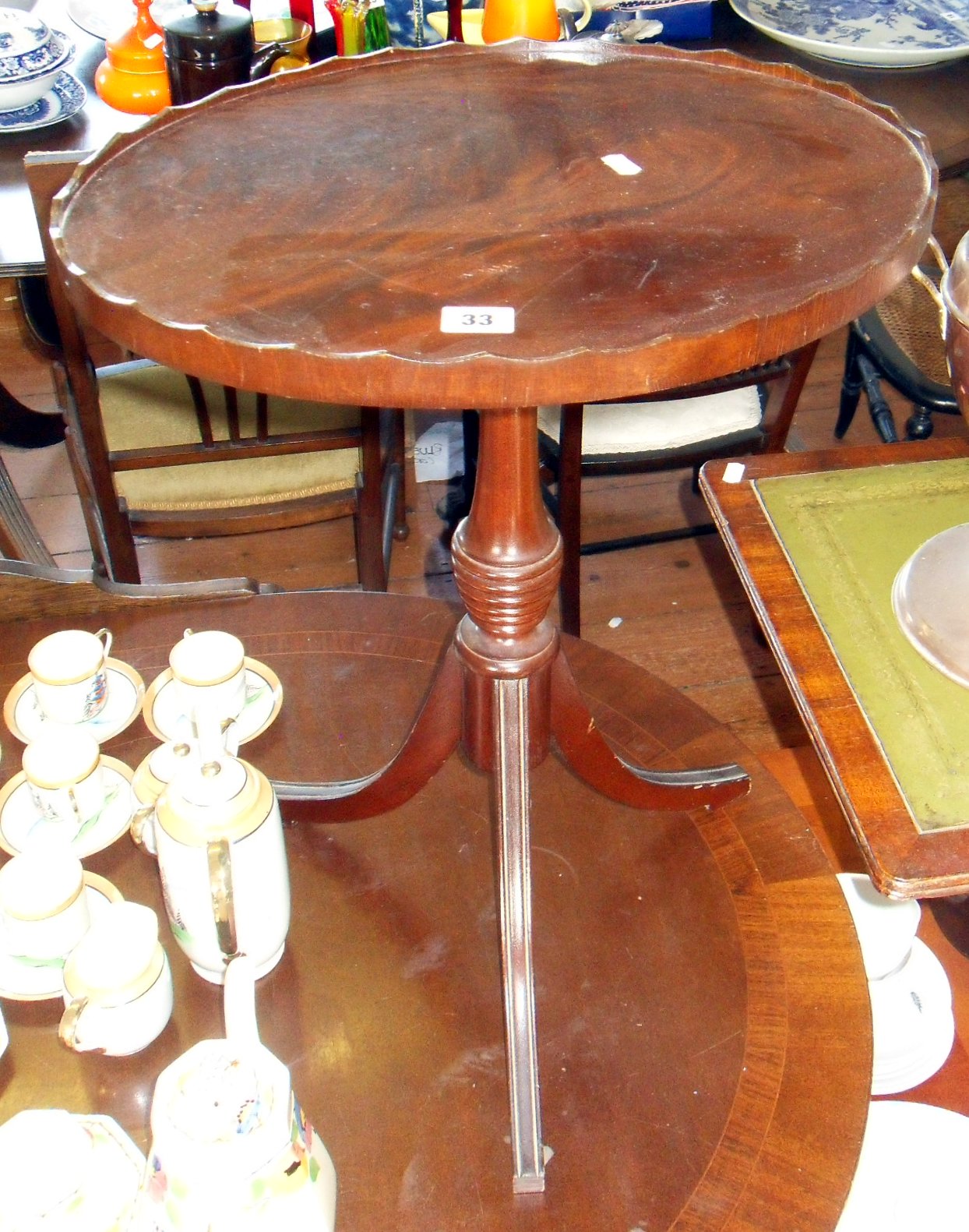 Oval scalloped-edge occasional table on tripod legs