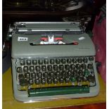 Olympia portable typewriter in metallic green case