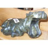 Polished stone carving of a yawning hippo