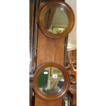 Pair of small round oak-framed wall mirrors