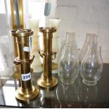 Pair of brass weighted wall candlesticks on gimbles with shades and a pair of onyx candlesticks