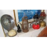 Two Tilley lamps, a Tilley heater, an old gas iron, and a hurricane lamp