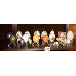 Collection of Continental porcelain hand-painted egg-shaped trinket boxes, and marble eggs on