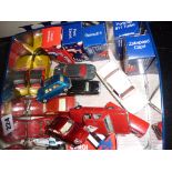 Tin containing vintage diecast vehicles, some still boxed, including Corgi Mini, Mini Marcos and