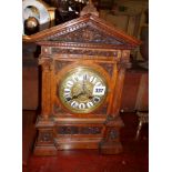 Victorian carved oak mantle clock with brass dial & enamel numerals