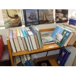 Two shelves of assorted books on Naval ships