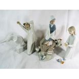 Lladro - two Lladro figurines depicting a boy stretching and yawning and a lady feeding a bird,