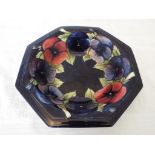 Moorcroft Pottery - a large octagonal sided pedestal bowl decorated with pansies on a cobalt blue