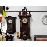 An imposing walnut cased Vienna style wall clock,