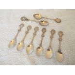 A collection of eight white metal crested spoons