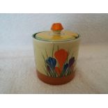 Clarice Cliff - a covered cylindrical preserve pot decorated in the Crocus pattern, 9.