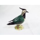 Beswick Pottery - a figurine depicting a lapwing finished in gloss #2416, 14 cm (h).