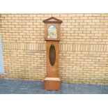 An early 20th century oak-cased longcase clock, the case having an oval,