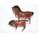 Royal Doulton / Beswick Pottery - two figurines depicting a mare and a foal,
