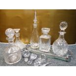 A good mixed lot of crystal decanters with serving tray and a selection various glass stoppers