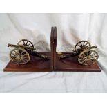 Two good quality book ends with brass cannons both bearing plaques one marked A Six Pound Field