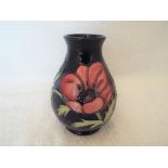 Moorcroft Pottery - a bulbous vase decorated with anemones on a cobalt blue ground,