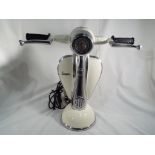 An unusual table lamp in the form of a Vespa scooter, approximate height 41 cm (h).