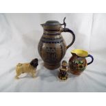 A mixed lot of ceramics to include a West German Jug with lid, a water jug,