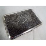 A sterling silver cigarette case with Siamese decoration to the case