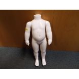 A mannequin in the form of a child (white) marked to the SY19M,