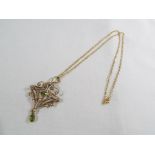 An antique peridot and seed pearl pendant with gold chain, approx. 5.