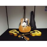 A 6-string acoustic guitar made in Italy by Eko together with two children's 6-string guitars and a