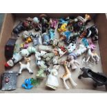 A collection of miniature ceramic figurines to include three Beswick, also Wade,