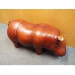 A good quality leather footstool in the form of a hippopotamus,