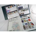 Philately - an album containing a collection of UK and world mounted postage stamps and a further