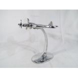 A chrome bomber airplane on stand Est £20