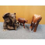 Three figurines depicting elephants and other