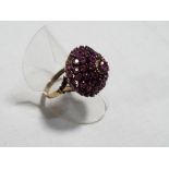 A lady's yellow gold ruby cluster ring, size N, approx. 5.