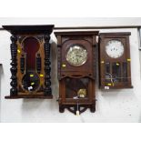 A late 19th century Gothic styled wall clock, walnut veneered case with glazed opening door,