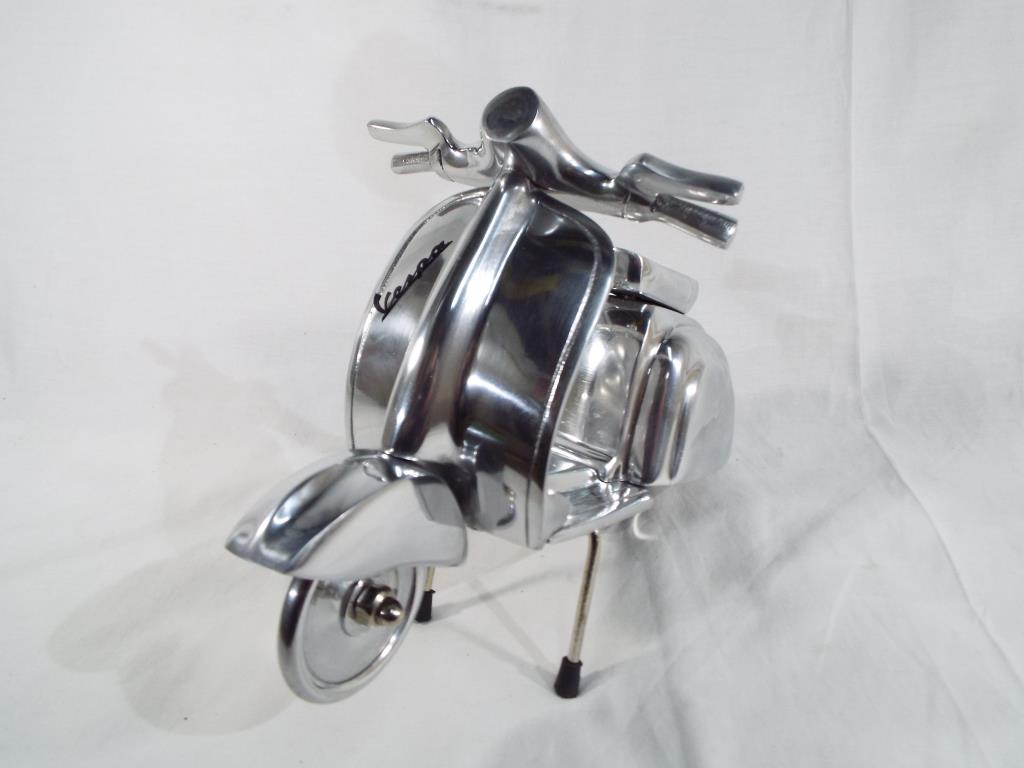 A miniature chrome Vespa scooter approx 20 cm (h) Est £30 - £50