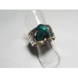 A lady's silver and turquoise matrix ring,