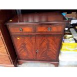 A modern cabinet with twin drawers on bracket feet