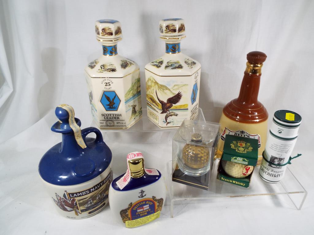 A 750 ml decanter of Lamb's Navy Rum, 200 ml flask of Pusser's Navy Rum, 26.