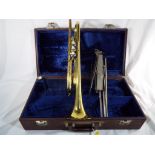 A good brass lacquered B flat trumpet by Elkhart, distributed by Vincent Bach International Ltd,