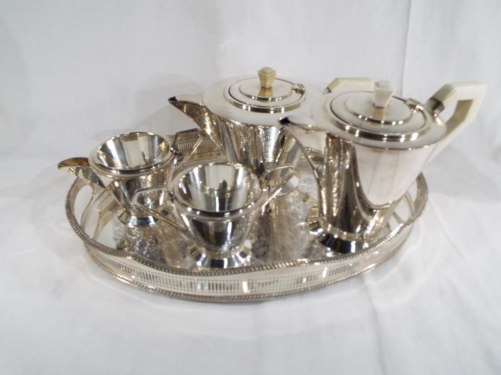 A modern plated tea set with serving tray