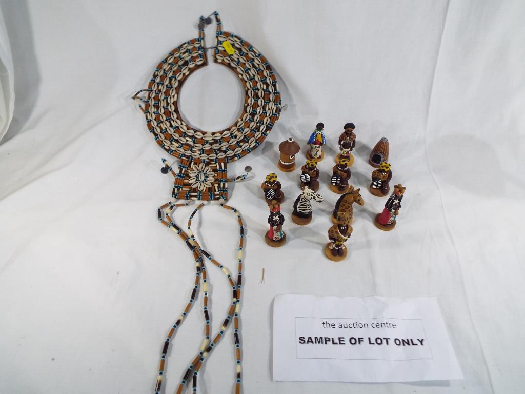 An African Maasai necklace and a set of South African chess pieces