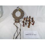 An African Maasai necklace and a set of South African chess pieces