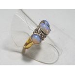 An antique opal and diamond dress ring set with three Cabochon opals and four old cut diamonds,