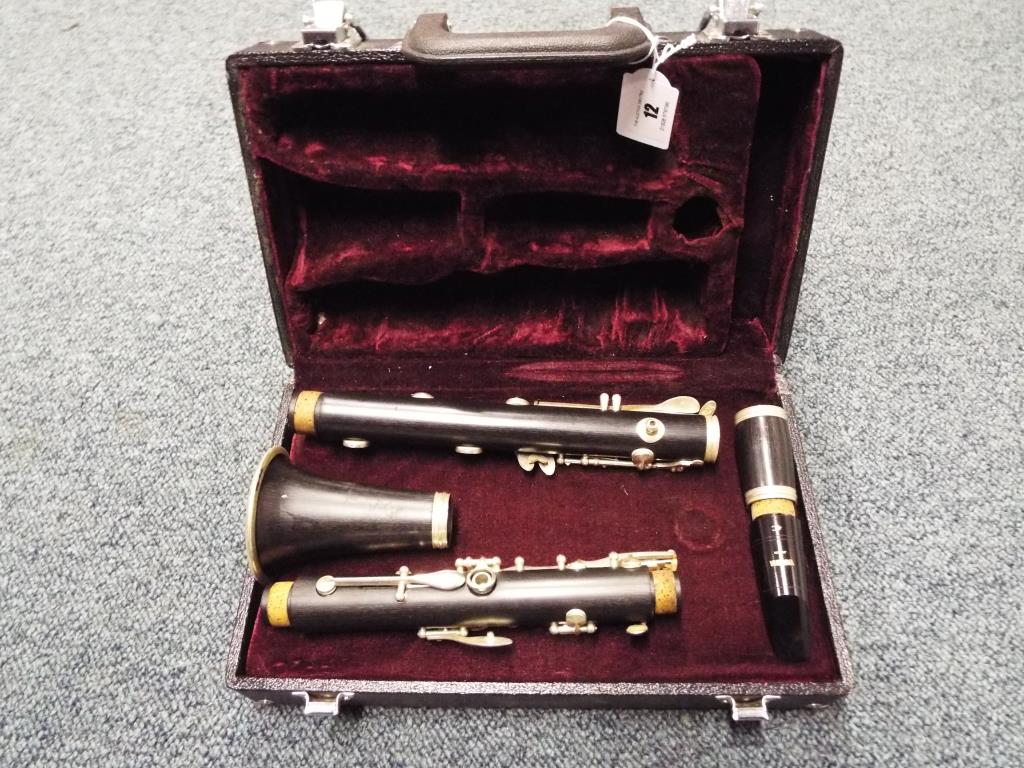 A clarinet by DY of the USA in original black hard case with Yamaha mouthpiece.