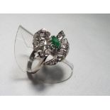 A lady's 18 carat white gold emerald and diamond cluster ring set with 28 diamonds, size P, approx.