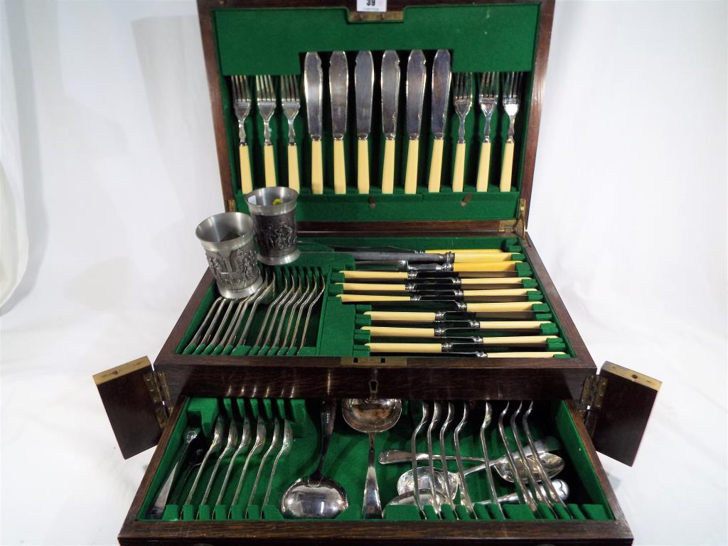 A good quality oak cased canteen of cutlery containing a quantity of bone handled and silver plated