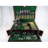 A good quality oak cased canteen of cutlery containing a quantity of bone handled and silver plated