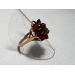 A lady's 9 carat yellow gold garnet cluster ring, size Q, approx. 3.