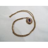 A 9 carat yellow gold amethyst and pearl locket with antique chain, approx. 22.